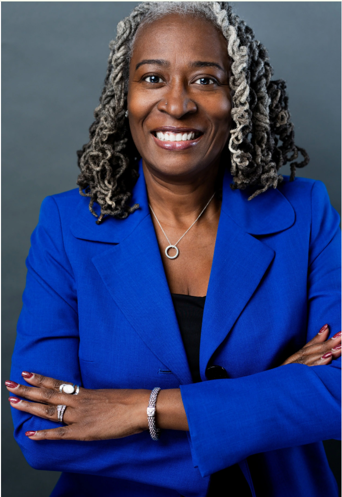 Karen S. McDonald smiling with arms crossed